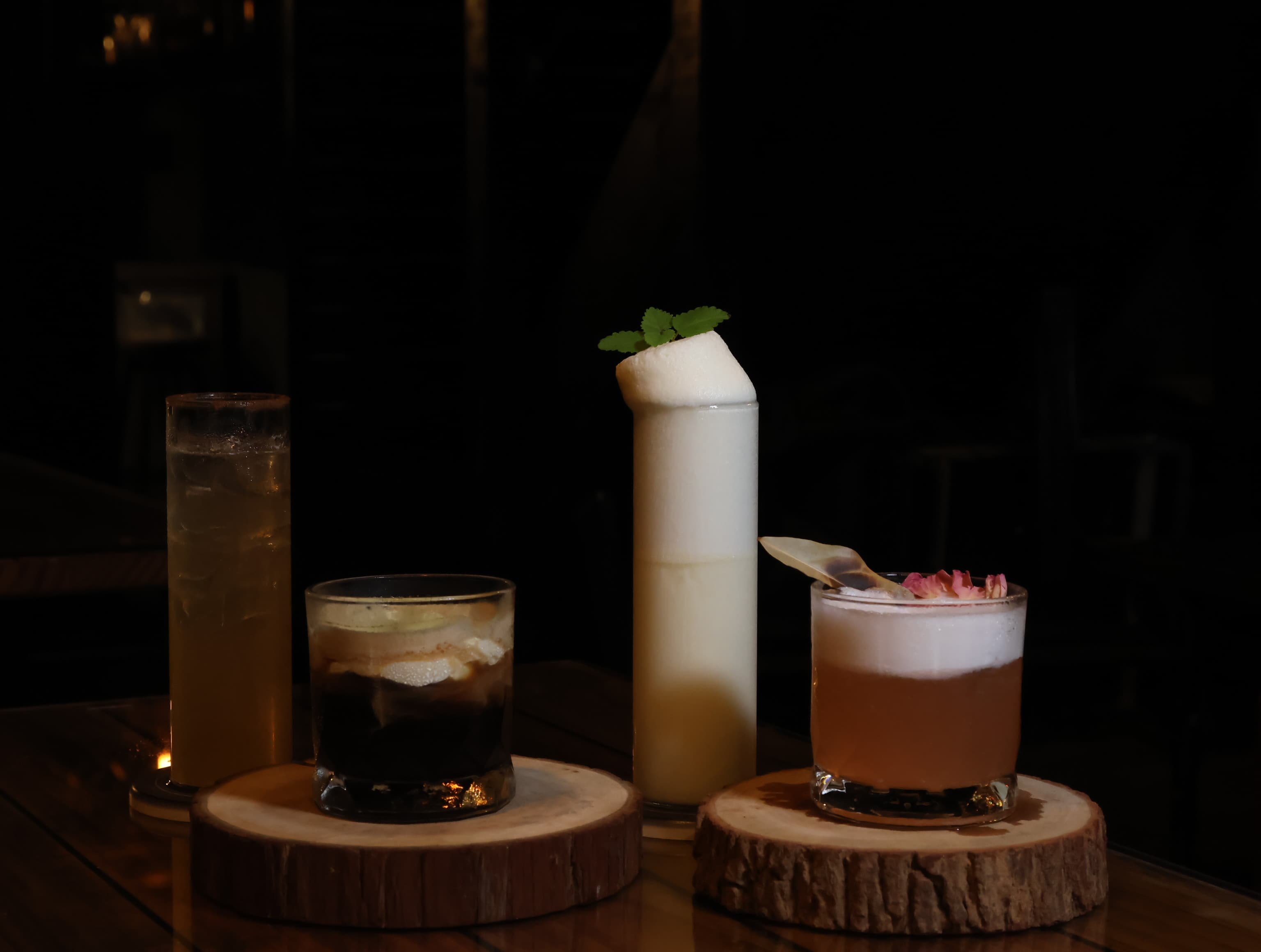 A flight of four cocktails