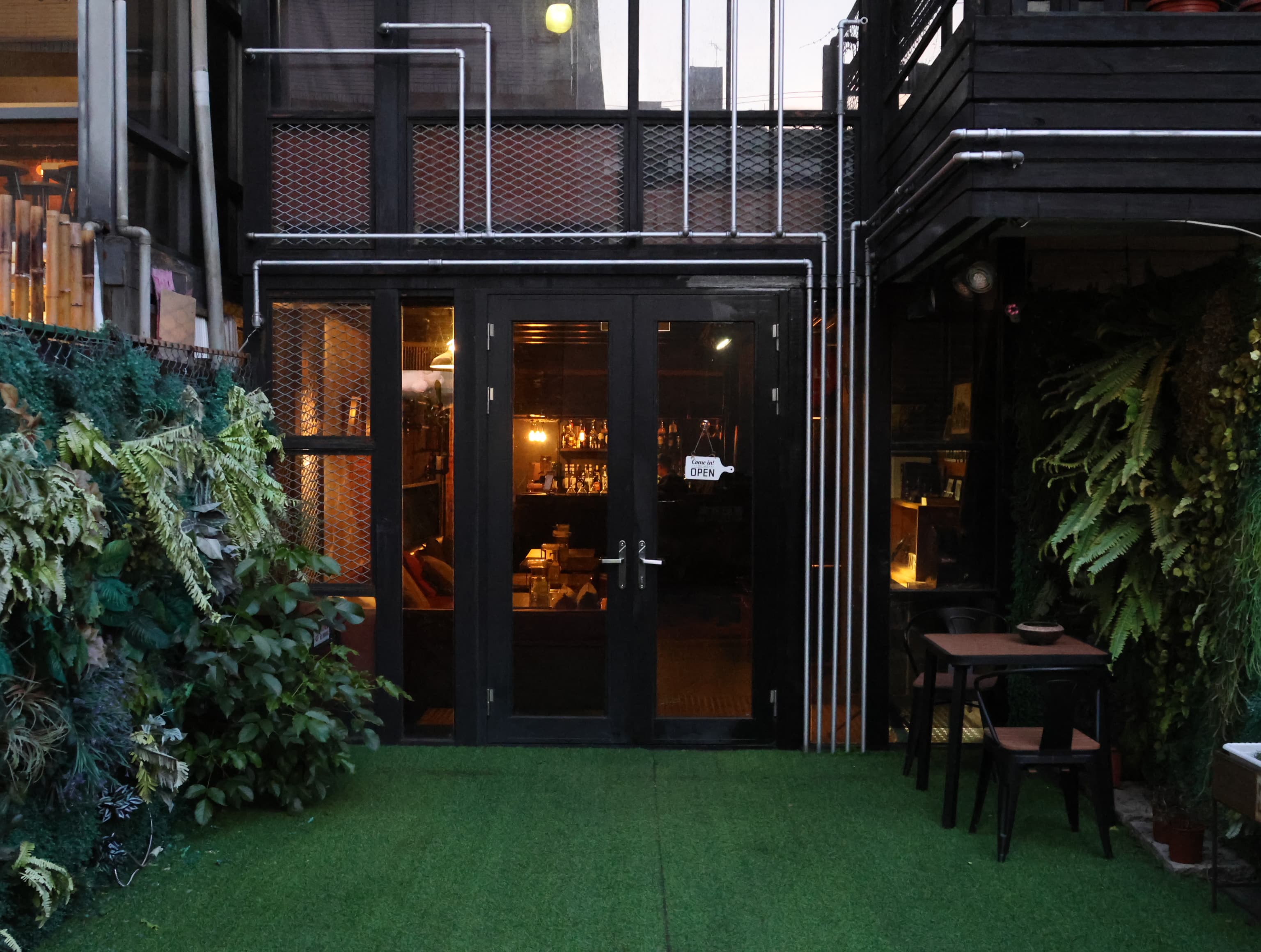 Bar TUBE entrance — industrial doorway and warm interior